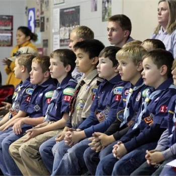 Cub Scouts present the colors and lead the audience in the pledge of allegiance